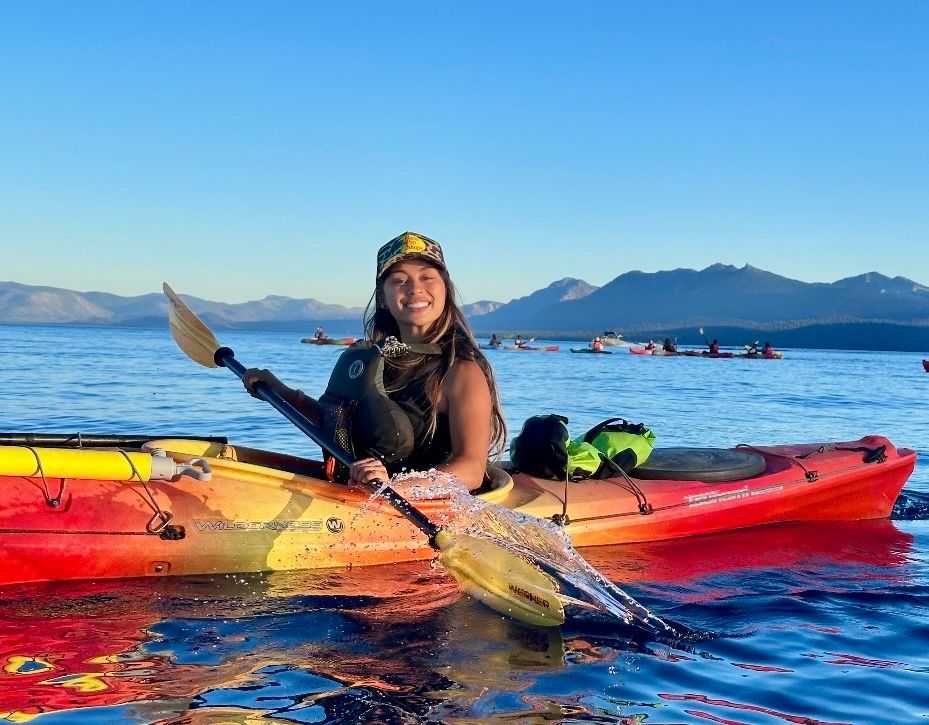 Angele K kayak guide enjoying sunset paddling on Lake Tahoe