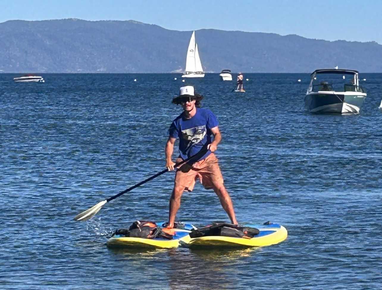Henry D showing off his dual paddle board skills on Lake Tahoe